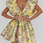 In house mini featuring a puffed neckline and pleating detail in the waist. 