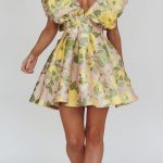 In house mini featuring a puffed neckline and pleating detail in the waist. 